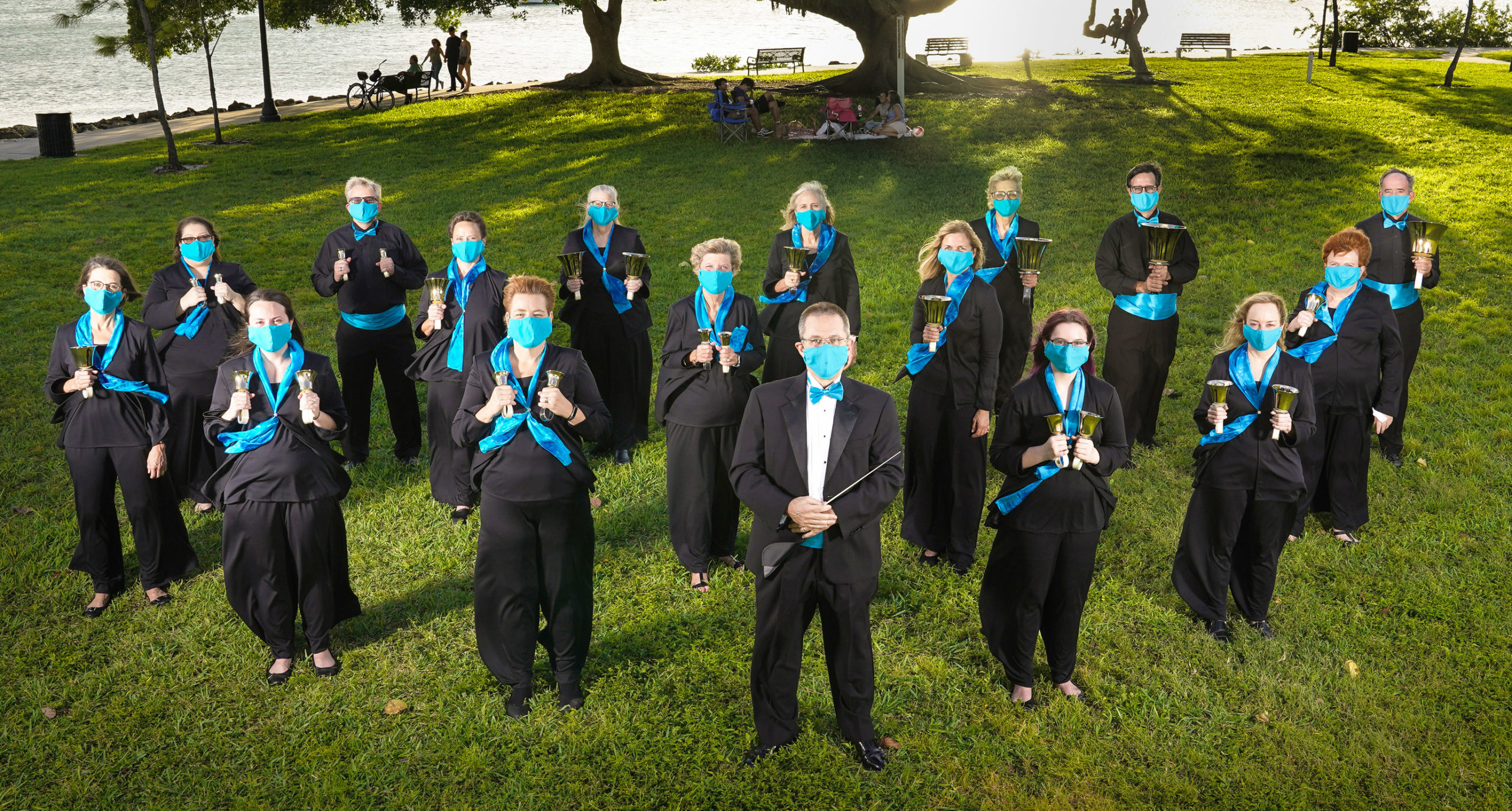 Handbell Ringers standing in formation holding handbells